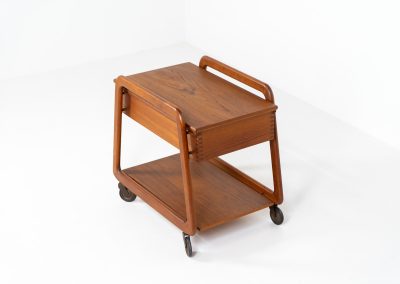Teak serving trolley by Sika Møbler (Denmark, 1960s). An elegant and versatile piece crafted from warm teak. It features clean lines, dovetail joinery, and a functional two-tier design with a convenient drawer for storage. The trolley is mounted on smooth-rolling casters, making it both stylish and practical for serving or displaying items. The trolley remains in mint condition.