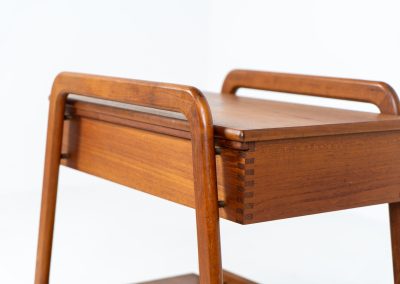 Teak serving trolley by Sika Møbler (Denmark, 1960s). An elegant and versatile piece crafted from warm teak. It features clean lines, dovetail joinery, and a functional two-tier design with a convenient drawer for storage. The trolley is mounted on smooth-rolling casters, making it both stylish and practical for serving or displaying items. The trolley remains in mint condition.