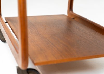 Teak serving trolley by Sika Møbler (Denmark, 1960s). An elegant and versatile piece crafted from warm teak. It features clean lines, dovetail joinery, and a functional two-tier design with a convenient drawer for storage. The trolley is mounted on smooth-rolling casters, making it both stylish and practical for serving or displaying items. The trolley remains in mint condition.