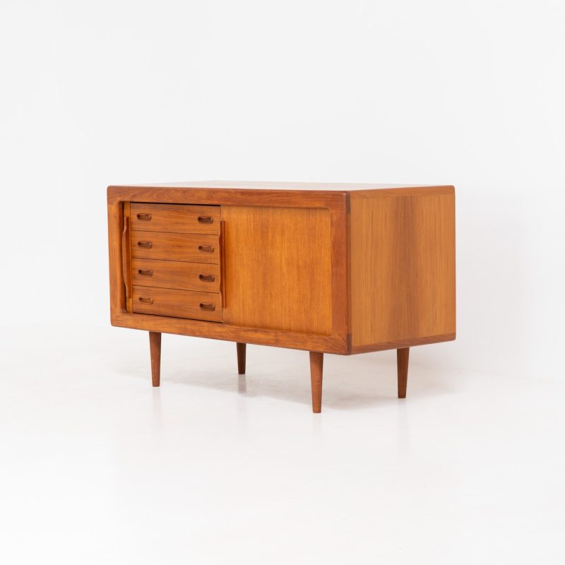 Svend Dyrlund teak sideboard with tambour doors (Denmark, 1960s). A wonderful sideboard with sought after dimensions. It perfectly combines very organic shapes and loads of detail, like the tambour sliding doors and the beautiful handles. It offers lots of storage space with an adjustable shelve and four beautiful drawers on the inside. An ideal piece for storing a record player and vinyls. This piece remains in very good condition!