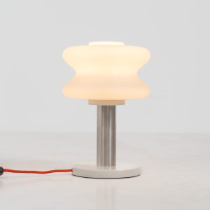 Modernist table lamp by AKA (Germany, 1960s). A beautiful table lamp with a heavy metal base, a brushed aluminium stem and and organically shaped, opal glass shade. The lamp is newly rewired and in very good condition!