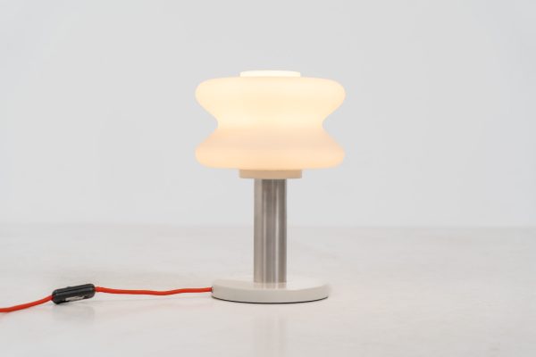 Modernist table lamp by AKA (Germany, 1960s). A beautiful table lamp with a heavy metal base, a brushed aluminium stem and and organically shaped, opal glass shade. The lamp is newly rewired and in very good condition!