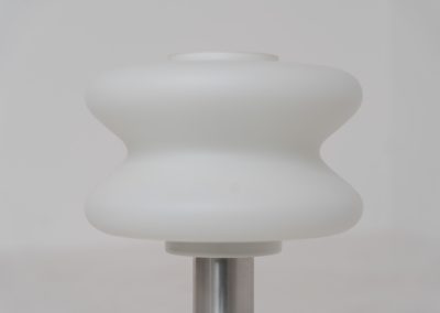 Modernist table lamp by AKA (Germany, 1960s). A beautiful table lamp with a heavy metal base, a brushed aluminium stem and and organically shaped, opal glass shade. The lamp is newly rewired and in very good condition!