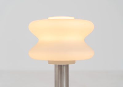 Modernist table lamp by AKA (Germany, 1960s). A beautiful table lamp with a heavy metal base, a brushed aluminium stem and and organically shaped, opal glass shade. The lamp is newly rewired and in very good condition!