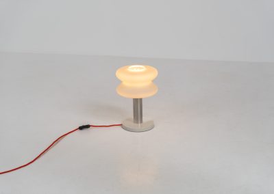 Modernist table lamp by AKA (Germany, 1960s). A beautiful table lamp with a heavy metal base, a brushed aluminium stem and and organically shaped, opal glass shade. The lamp is newly rewired and in very good condition!