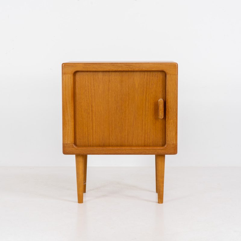 Compact cabinet with tambour door by CFC Silkeborg (Denmark, 1960s). The cabinet is made out of teak and features stunning organic shapes and lots of amazing details, like the tambour door and the rounded handle. The shelve on the inside is adjustable. This piece presents itself in very condition with no damages.