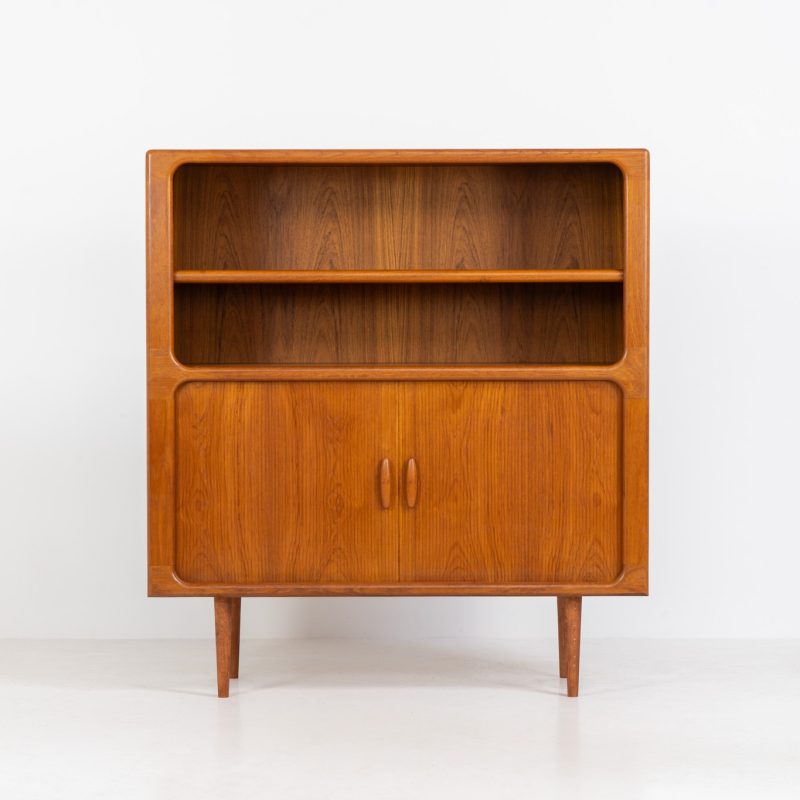 Beautiful bookcase in teak by Svend Dyrlund with tambour doors (Denmark, 1960s). This bookcase perfectly combines organic shapes and loads of details, like the tambour sliding doors, the beautiful handles or the bulky shelves, which are adjustable in height. It offers lots of storage space! In mint condition!