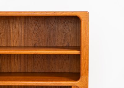 Beautiful bookcase in teak by Svend Dyrlund with tambour doors (Denmark, 1960s). This bookcase perfectly combines organic shapes and loads of details, like the tambour sliding doors, the beautiful handles or the bulky shelves, which are adjustable in height. It offers lots of storage space! In mint condition!