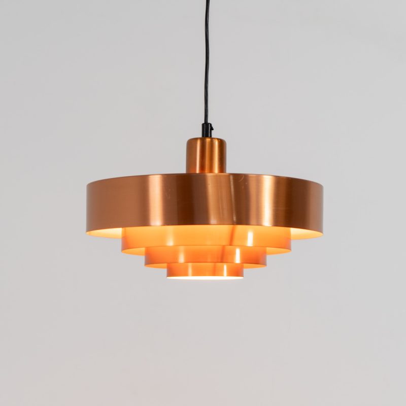 Copper “Roulette” pendant light by Jo Hammerborg for Fog & Mørup (Denmark, 1960s). In our opinion, this is one of Hammerborg’s most stunning designs and increasingly hard to find. Made from solid copper rings with orange detailing on the interior, this lamp is a striking piece, both on and off. It’s in excellent condition.