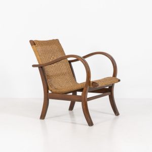 Bauhaus armchair by Erich Dieckmann (Germany, 1930s). This elegant armchair dates from the 1930s, designed by Erich Dieckmann. It features a stained beech frame and a wicker seat. It's in its original condition but is perfectly stable, clean, and functional. The chair is in a nice preserved and untouched vintage condition with a beautiful lived-in patina.