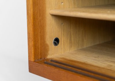 Rare and important RY26 sideboard by Hans J. Wegner for Ry Møbler (Denmark, 1950s). This incredible piece is composed of delicately grained oak with a stunning honey hued stain. It contains two large sliding doors with round inset handles, adjustable shelves and four modular drawers on the inside. This hard to find piece remains in very good vintage condition. It is designed by the the renowned Hans J. Wegner who won multiple awards and honors throughout his carreer.