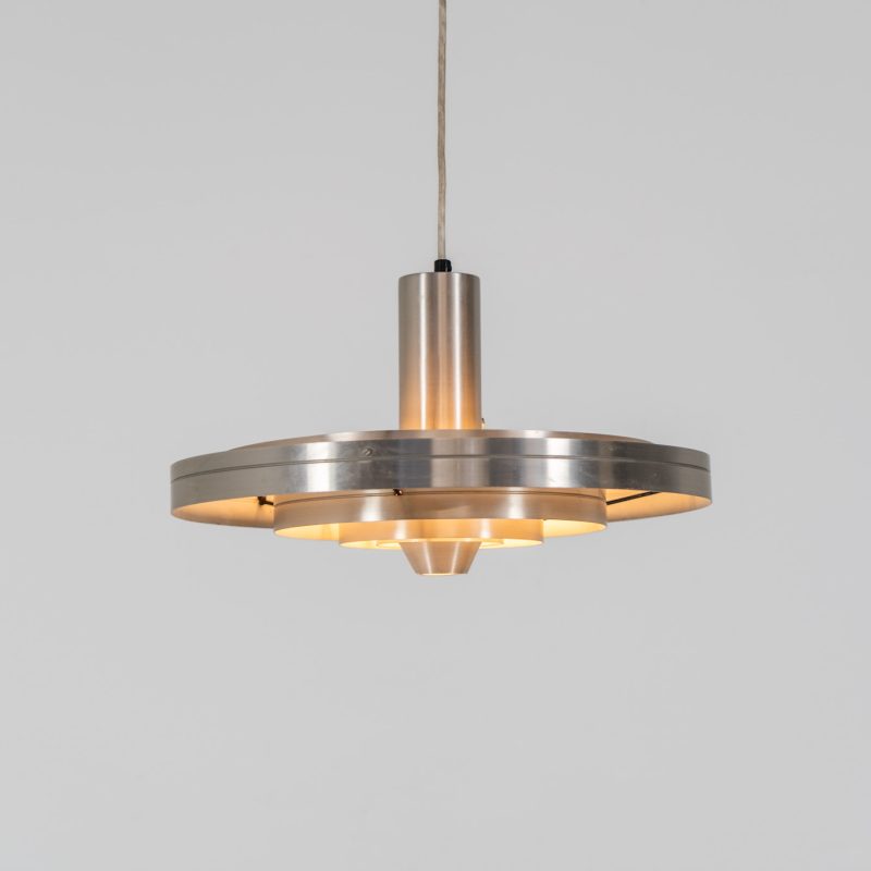 “Fibonacci” pendant light by Sophus Frandsen for Fog & Mørup (Denmark, 1960s). The Fibonacci lamp uses a gravity-guided sliding dip mechanism: the shade glides along the rail and naturally ‘dips’ into position, allowing effortless adjustment of light direction and intensity, a hallmark of Sophus Frandsen’s engineering-minded approach to lighting. The lamp is in very good vintage condition with some visible scratches and age related marks. Marked by maker.