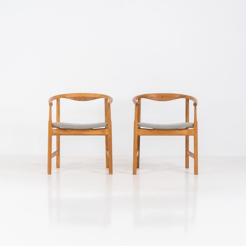 Pair of PP203 arm chairs by Hans J. Wegner for PP Møbler (Denmark, 1960s). The PP203 chair, also called “First Chair” is an iconic design by the renowned Hans Wegner and is crafted out of solid oak and highly detailed wengé joinery. These beauties are in very good condition and marked by maker.