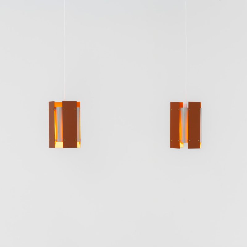 Stunning pair of pendant lights by Lyfa (Denmark, 1960s). These spectacular lamps are made out of multiple steel slats lacquered in orange, brown and grey, which gives an amazing lighting. The lamps look different from every angle and will definitely never bore you! Newly rewired and in splendit condition.