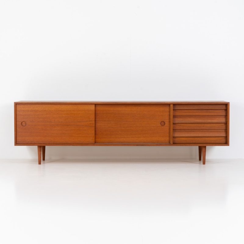 Low “Platon” sideboard by Lothar Wegner (Germany, 1960s). It features two big sliding doors, three drawers and lots of storage space. The combination of the sleek lines and the organic drawers is just amazing. It has subtle round inset handles and a beautiful warm woodgrain. The sideboard is in beautiful condition with a little bit of color difference on the top.