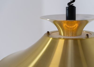 Brass colored pendant light by Frandsen (Denmark, 1970s). A beautiful lamp made out of four aluminium shades with a brass colored exterior. Featuring the original height-adjustable cord. The lamp remains in splendid condition.