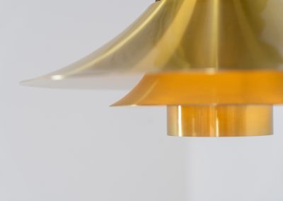 Brass colored pendant light by Frandsen (Denmark, 1970s). A beautiful lamp made out of four aluminium shades with a brass colored exterior. Featuring the original height-adjustable cord. The lamp remains in splendid condition.