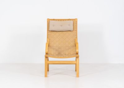 Albert chair by Finn Ostergaard for Skipper (Denmark, 1970s). A beautiful and sculptural armchair that consists of a beech bentwood frame, a woven canvas-strap webbing and an adjustable canvas headrest, finished with leather details. In good condition with a nice patina on the straps & canvas.