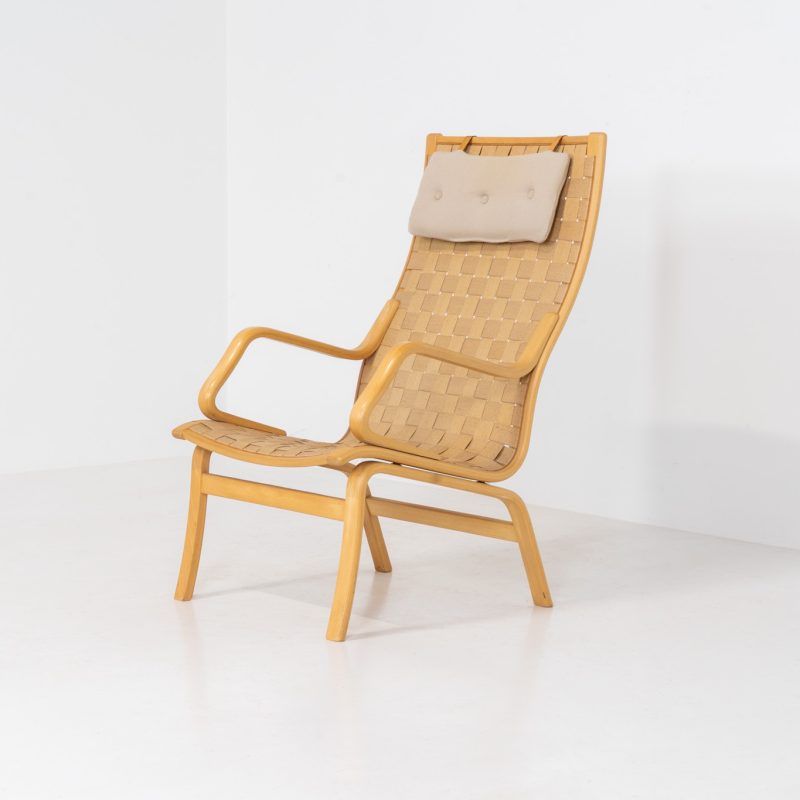 Albert chair by Finn Ostergaard for Skipper (Denmark, 1970s). A beautiful and sculptural armchair that consists of a beech bentwood frame, a woven canvas-strap webbing and an adjustable canvas headrest, finished with leather details. In good condition with a nice patina on the straps & canvas.