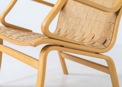 Albert chair by Finn Ostergaard for Skipper (Denmark, 1970s). A beautiful and sculptural armchair that consists of a beech bentwood frame, a woven canvas-strap webbing and an adjustable canvas headrest, finished with leather details. In good condition with a nice patina on the straps & canvas.