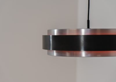 “Sera” pendant light by Jo Hammerborg for Fog & Mørup (Denmark, 1960s). A wonderful example of Danish modernism! This Sera pendel has a sleek, timeless and stunning appearance. Crafted with two brushed aluminium shades, a black lacquered halo and an acrylic light diffuser. The inside of the halo is lacquered in pink, which gives that extra dimension in the light dispersion when turned on. The lamp is in very good vintage condition!