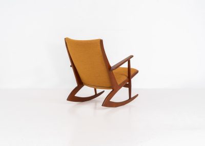 Stunning rocking chair by Georg Jensen for Kubus (Denmark, 1950s). This exceptional piece features a solid teak frame with beautiful organic lines and cushions that were recently reupholstered in an ocher yellow fabric. The chair is very comfortable, highly detailed and extremely beautiful.