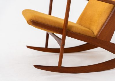 Stunning rocking chair by Georg Jensen for Kubus (Denmark, 1950s). This exceptional piece features a solid teak frame with beautiful organic lines and cushions that were recently reupholstered in an ocher yellow fabric. The chair is very comfortable, highly detailed and extremely beautiful.