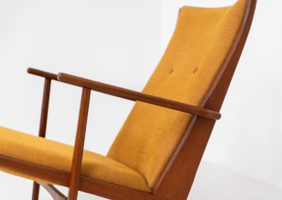 Stunning rocking chair by Georg Jensen for Kubus (Denmark, 1950s). This exceptional piece features a solid teak frame with beautiful organic lines and cushions that were recently reupholstered in an ocher yellow fabric. The chair is very comfortable, highly detailed and extremely beautiful.