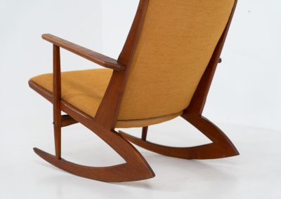 Stunning rocking chair by Georg Jensen for Kubus (Denmark, 1950s). This exceptional piece features a solid teak frame with beautiful organic lines and cushions that were recently reupholstered in an ocher yellow fabric. The chair is very comfortable, highly detailed and extremely beautiful.