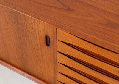 Rare “OS29” sideboard by Arne Vodder for Sibast (Denmark, 1950s). This highly important and collectible masterpiece by Arne Vodder is a rarity to find in good condition. The OS29 has perfect proportions, beautiful aesthetics and a high quality finish. It is crafted out of teak and features a turnable black door, 5 bow tie shaped drawers, adjustable shelves and a raised back edge. This piece remains in very good condition with a few small repair marks and using traces, as shown on the pictures. It is marked and stamped by the maker.