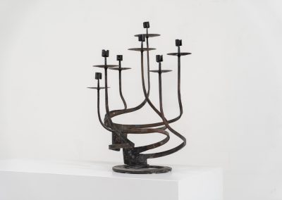 Stunning brutalist candelabra in the manner of Jean Touret for Arelier Marolles (France, 1950s). A highly sculptural cast iron candelabra featuring seven candle holders and a stunning patina.
