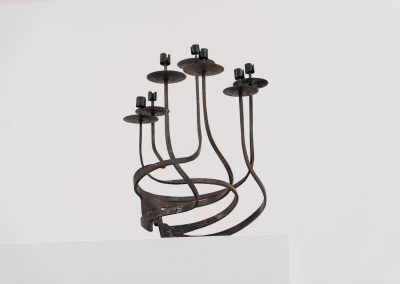 Stunning brutalist candelabra in the manner of Jean Touret for Arelier Marolles (France, 1950s). A highly sculptural cast iron candelabra featuring seven candle holders and a stunning patina.