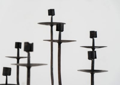 Stunning brutalist candelabra in the manner of Jean Touret for Arelier Marolles (France, 1950s). A highly sculptural cast iron candelabra featuring seven candle holders and a stunning patina.