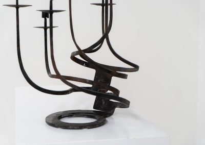 Stunning brutalist candelabra in the manner of Jean Touret for Arelier Marolles (France, 1950s). A highly sculptural cast iron candelabra featuring seven candle holders and a stunning patina.