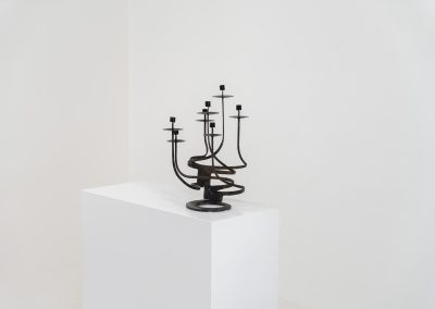 Stunning brutalist candelabra in the manner of Jean Touret for Arelier Marolles (France, 1950s). A highly sculptural cast iron candelabra featuring seven candle holders and a stunning patina.