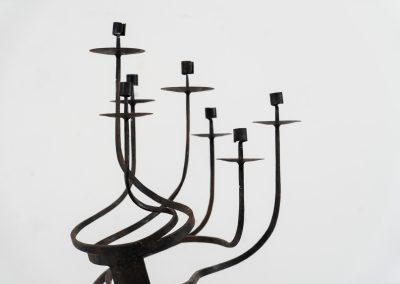 Stunning brutalist candelabra in the manner of Jean Touret for Arelier Marolles (France, 1950s). A highly sculptural cast iron candelabra featuring seven candle holders and a stunning patina.