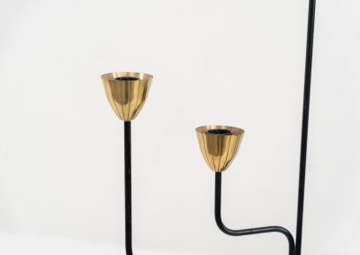 Elegant candelabra in brass and metal by Gunnar Ander for Ystad-Metal (Sweden, 1950s). This refined candelabra features slender, black-lacquered bent metal supports combined with solid brass candle holders, creating a striking contrast. The piece is in very good vintage condition. The brass shows a beautiful, even patina that enhances its character and authenticity. Marked by maker.