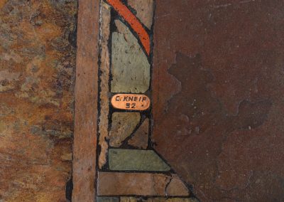 Brutalist coffee table by C. Kneip (Germany, 1990s). A powerful and sculptural brutalist coffee table by German designer C. Kneip, dating from the 1990s. The design is defined by its expressive materiality and architectural presence. The substantial tabletop is crafted from Indian slate and enriched with inlaid elements of lava stone, copper, and brass. These materials are arranged in a richly textured, almost relief-like composition, creating a striking interplay of color, surface, and depth. The heavy stone top is supported by a black lacquered wooden base, providing a sense of grounded solidity. The table is marked by the maker and retains its original certificate. Presented in splendid condition.