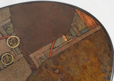 Brutalist coffee table by C. Kneip (Germany, 1990s). A powerful and sculptural brutalist coffee table by German designer C. Kneip, dating from the 1990s. The design is defined by its expressive materiality and architectural presence. The substantial tabletop is crafted from Indian slate and enriched with inlaid elements of lava stone, copper, and brass. These materials are arranged in a richly textured, almost relief-like composition, creating a striking interplay of color, surface, and depth. The heavy stone top is supported by a black lacquered wooden base, providing a sense of grounded solidity. The table is marked by the maker and retains its original certificate. Presented in splendid condition.