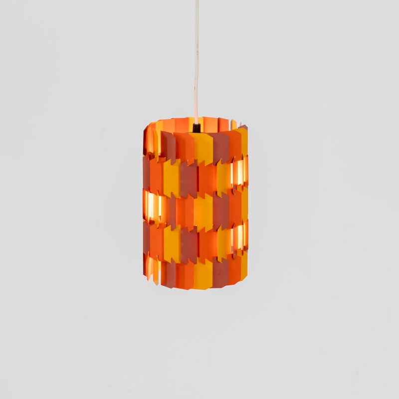 “Facet Pop” pendant light by Louis Weisdorf for Lyfa (Denmark, 1960s). A striking and highly sculptural pendant light designed by Louis Weisdorf for Lyfa in the 1960s. The lamp is constructed from multiple interlocking metal panels, lacquered in three vibrant colours, creating a dynamic play of light and shadow. Due to its complex and costly production process, this model was manufactured for only a short period, making it a rare and sought-after design today. An exceptional and colourful eye-catcher in very good condition. Marked by the manufacturer and newly rewired.