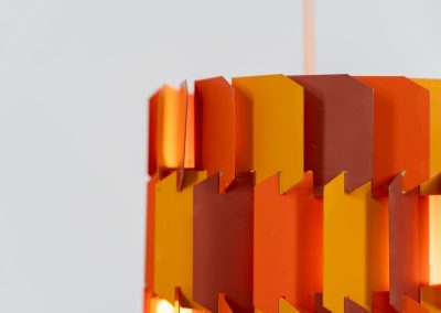 “Facet Pop” pendant light by Louis Weisdorf for Lyfa (Denmark, 1960s). A striking and highly sculptural pendant light designed by Louis Weisdorf for Lyfa in the 1960s. The lamp is constructed from multiple interlocking metal panels, lacquered in three vibrant colours, creating a dynamic play of light and shadow. Due to its complex and costly production process, this model was manufactured for only a short period, making it a rare and sought-after design today. An exceptional and colourful eye-catcher in very good condition. Marked by the manufacturer and newly rewired.