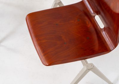 Set of 6 “S22” industrial dining chairs by Elmar Flototto for Pagholz (Germany, 1960s). This set of six original S22 industrial dining chairs, designed by Elmar Flötotto for Pagholz, dates from the 1960s and was produced in Germany. The chairs feature a rare and highly sought-after combination of rosewood-toned moulded Pagholz seats paired with crème powder-coated steel frames. Their clean, functional design reflects the strong industrial aesthetic Pagholz is known for. All chairs are fully stackable and come with the original stacking trolley, a seldom-found and highly desirable addition. The set is in very good vintage condition, showing only minor signs of wear consistent with age and use, without structural issues. A timeless and characterful set, suitable for both dining and contract interiors, and a strong example of post-war German industrial design.