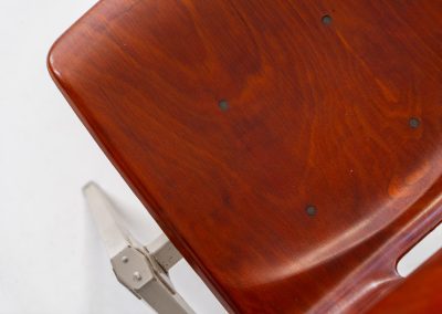 Set of 6 “S22” industrial dining chairs by Elmar Flototto for Pagholz (Germany, 1960s). This set of six original S22 industrial dining chairs, designed by Elmar Flötotto for Pagholz, dates from the 1960s and was produced in Germany. The chairs feature a rare and highly sought-after combination of rosewood-toned moulded Pagholz seats paired with crème powder-coated steel frames. Their clean, functional design reflects the strong industrial aesthetic Pagholz is known for. All chairs are fully stackable and come with the original stacking trolley, a seldom-found and highly desirable addition. The set is in very good vintage condition, showing only minor signs of wear consistent with age and use, without structural issues. A timeless and characterful set, suitable for both dining and contract interiors, and a strong example of post-war German industrial design.