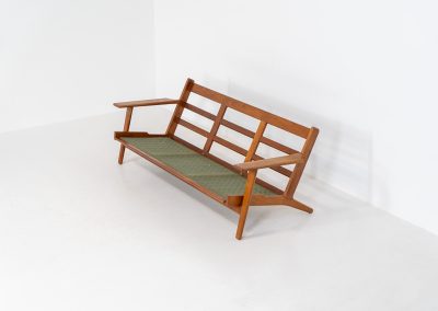 Early GE-290 3-seater sofa in oak by Hans J. Wegner for Getama (Denmark, 1953). An iconic early example of Hans J. Wegner's GE-290 , produced by Getama in Denmark in 1953. This celebrated design is renowned for its sculptural yet restrained form and exceptional comfort. The sofa features a dark-stained solid oak frame paired with beige wool cushions, creating a timeless and well-balanced contrast that highlights Wegner's mastery of materials and proportion. Presented in splendid condition, with the frame and upholstery beautifully preserved. We also have a GE290A + ottoman and a GE290 lounge chair available in stock.