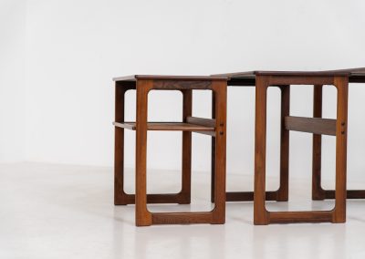 “Model 219” nesting tables by Johannes Andersen & Illum Wickelso for CFC Silkeborg (Denmark, 1960s). These tables are crafted from rosewood and feature a sleek and functional design, allowing them to nest seamlessly within one another. They offer amazing details like the rattan magazine shelf, the mesmerizing woodgrain and the stunning wood connections Versatile and stylish, they serve perfectly as side tables or coffee tables, adapting effortlessly to various interior settings. All three tables are in mint condition. Marked by maker.