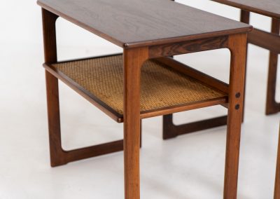 “Model 219” nesting tables by Johannes Andersen & Illum Wickelso for CFC Silkeborg (Denmark, 1960s). These tables are crafted from rosewood and feature a sleek and functional design, allowing them to nest seamlessly within one another. They offer amazing details like the rattan magazine shelf, the mesmerizing woodgrain and the stunning wood connections Versatile and stylish, they serve perfectly as side tables or coffee tables, adapting effortlessly to various interior settings. All three tables are in mint condition. Marked by maker.