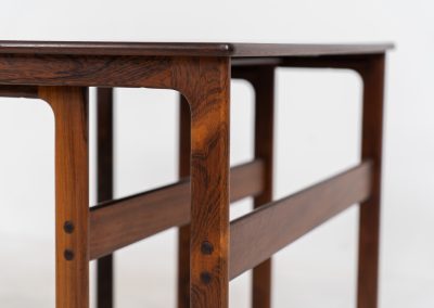 “Model 219” nesting tables by Johannes Andersen & Illum Wickelso for CFC Silkeborg (Denmark, 1960s). These tables are crafted from rosewood and feature a sleek and functional design, allowing them to nest seamlessly within one another. They offer amazing details like the rattan magazine shelf, the mesmerizing woodgrain and the stunning wood connections Versatile and stylish, they serve perfectly as side tables or coffee tables, adapting effortlessly to various interior settings. All three tables are in mint condition. Marked by maker.