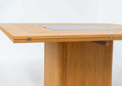 “Cirkante” dining table by Bob & Dries Vanden Berghe for Vanden Berghe Pauvers (Belgium, 1980s). This Belgian icon by Bob Van den Berghe is a masterclass in geometric functionalism. With its signature folding leaves, the Cirkante transforms from a solid square into a spacious octagon, expanding capacity from 8 to 12 people in seconds. By erasing the "head of the table" to put every guest at the center of the conversation. By removing the "head" of the table, its architectural form ensures every guest is at the heart of the conversation. Crafted from premium materials, it remains a timeless sculptural centerpiece for the modern collector. The table remains in amazing condition with minimal wear.