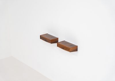 Pair of floating bedside tables in rosewood (Denmark, 1960s). This beautiful pair of bedside tables is easily mounted to the wall and contains a small drawer. They offer a minimalist appearance and a beautiful woodgrain. In very good condition with minimal traces of use visible.