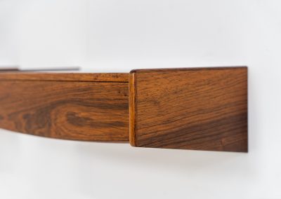 Pair of floating bedside tables in rosewood (Denmark, 1960s). This beautiful pair of bedside tables is easily mounted to the wall and contains a small drawer. They offer a minimalist appearance and a beautiful woodgrain. In very good condition with minimal traces of use visible.